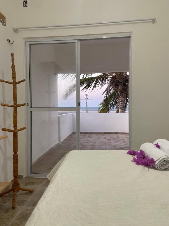 a bedroom with a bed with a view of the beach at VILLA Enzo in Acaraú