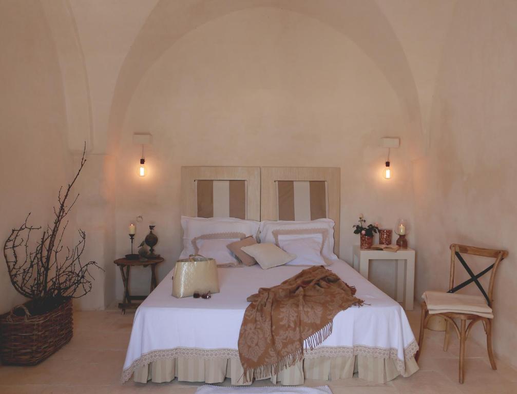 A bed or beds in a room at Masseria Le Carrube