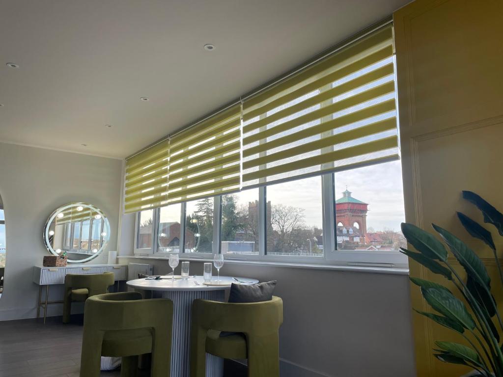 a dining room with a table and chairs and a window at Dutch Quarter in Colchester