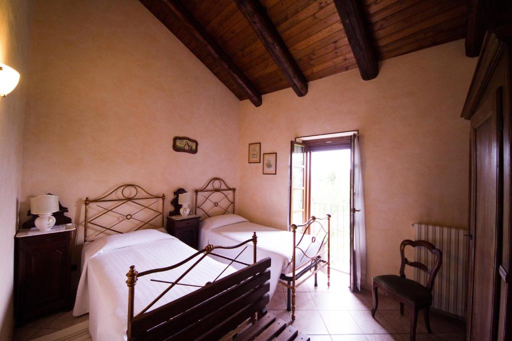 Postel nebo postele na pokoji v ubytování Agriturismo La Ca 'd Majin