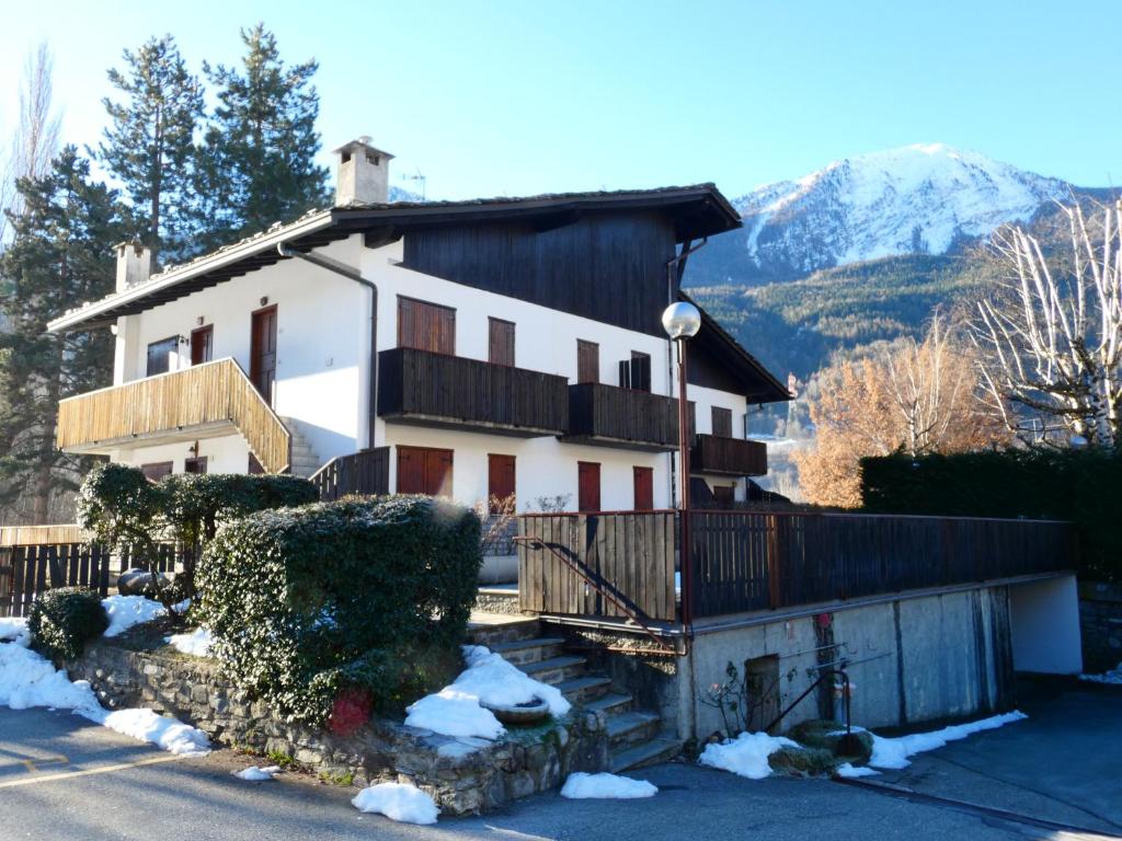 a house in the mountains with snow on the ground at Le Coucou de Thovex in Morgex