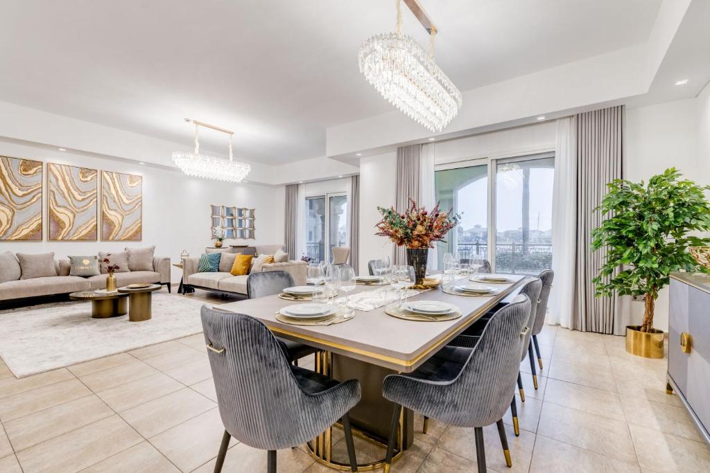 a dining room and living room with a table and chairs at GLOBALSTAY. Luxury 3 Bedroom + Maid Townhouse with Sea View in Dubai