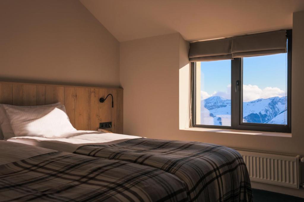 Postel nebo postele na pokoji v ubytování Alpina Hotel