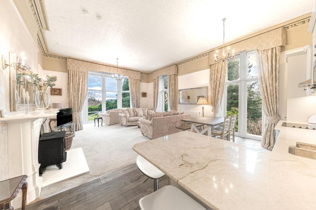a living room with a table and a couch at 1 Brathay Fell in Ambleside