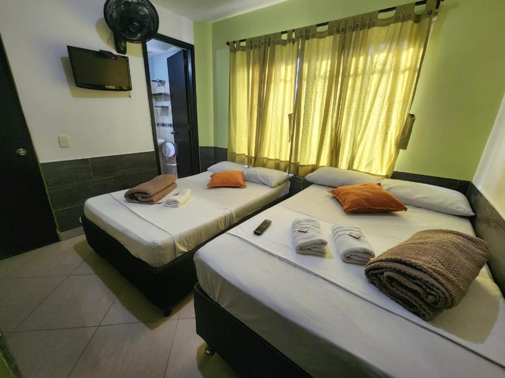 Postel nebo postele na pokoji v ubytování Hotel Laureles Home