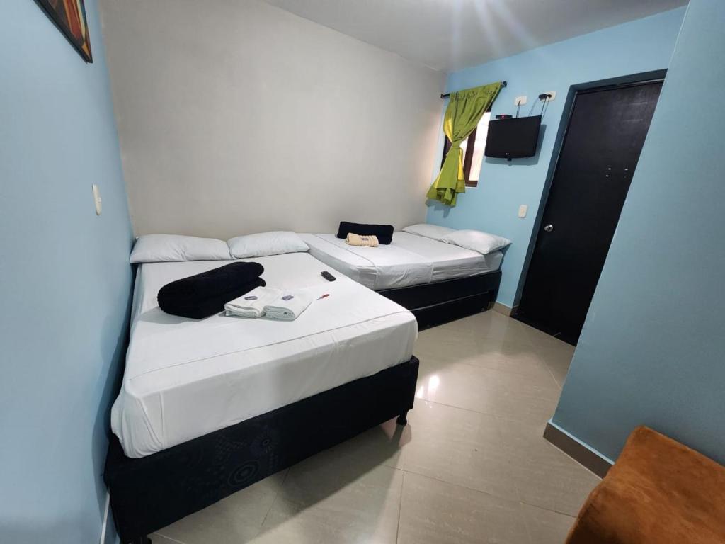 Postel nebo postele na pokoji v ubytování Hotel Laureles Home