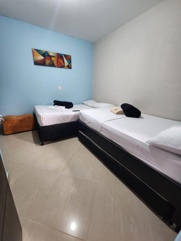Postel nebo postele na pokoji v ubytování Hotel Laureles Home
