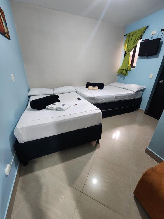 Postel nebo postele na pokoji v ubytování Hotel Laureles Home