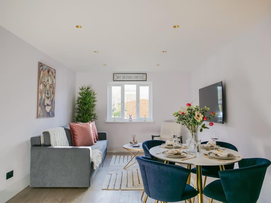 a living room with a table and chairs at Stylish Retreat for Your Short Getaway in London