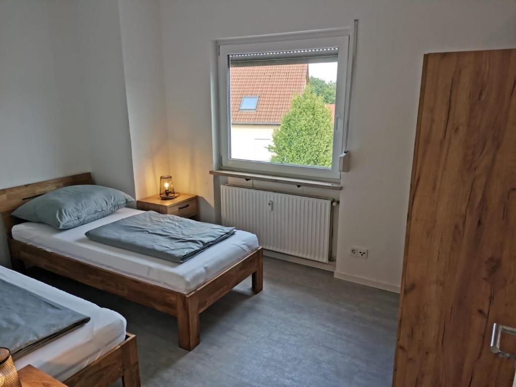 a bedroom with two beds and a window at Waldmohrer Hof in Waldmohr