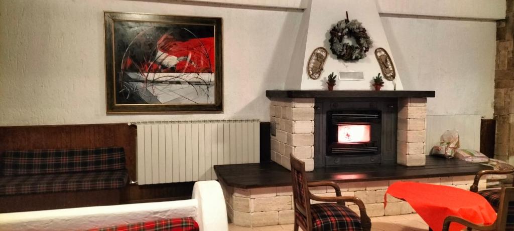 a living room with a fireplace and a tv at Residence PARADISO in Roccaraso