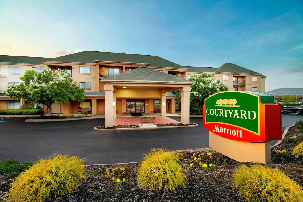 a hotel with a sign in front of a building at Courtyard by Marriott State College in State College