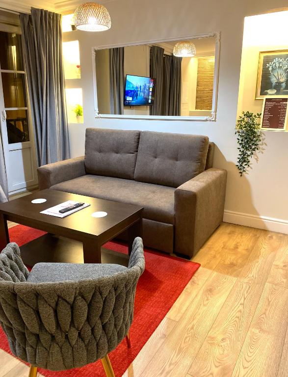 a living room with a couch and a table at Apartamentos Colmeia in Lisbon