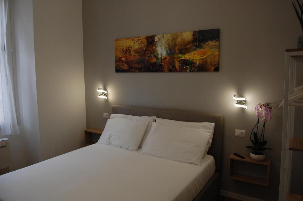 a bedroom with a bed and a painting on the wall at Belltower Elegans in Rome