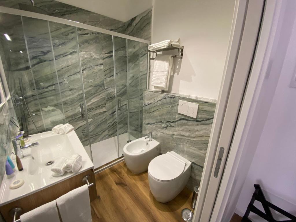 a bathroom with a sink and a toilet and a shower at Belltower Elegans in Rome