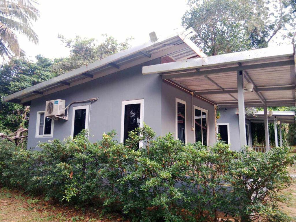 a small gray house with a roof at family resort in Ko Phayam