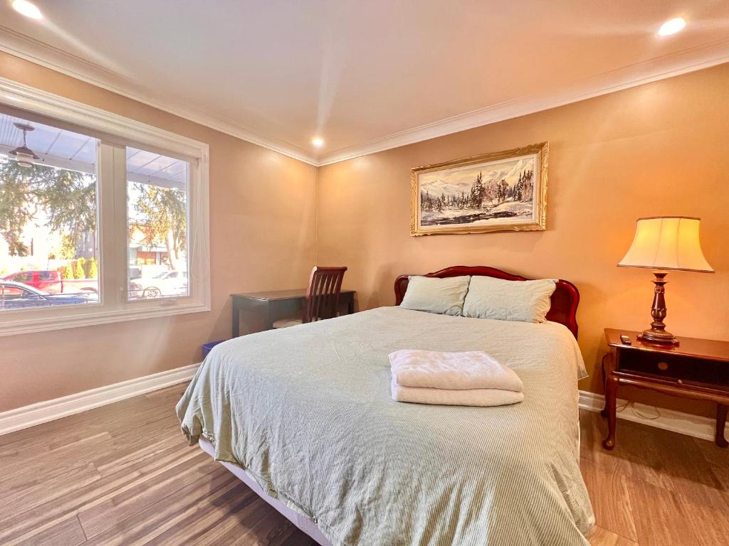 a bedroom with a bed and a window at Newly Renovated Home in Toronto Near Subway in Toronto