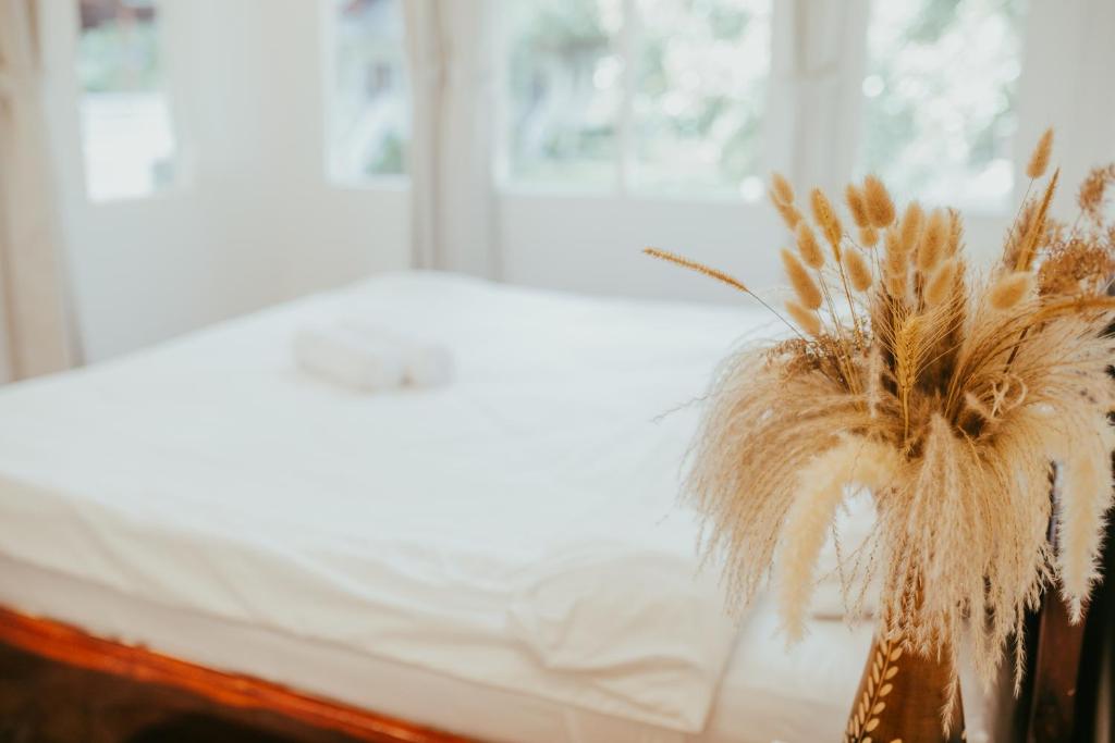 a bed with a bunch of pampas grass on it at MY HOME Resort - Koh phangan vacation house rentals in Ban Madua Wan