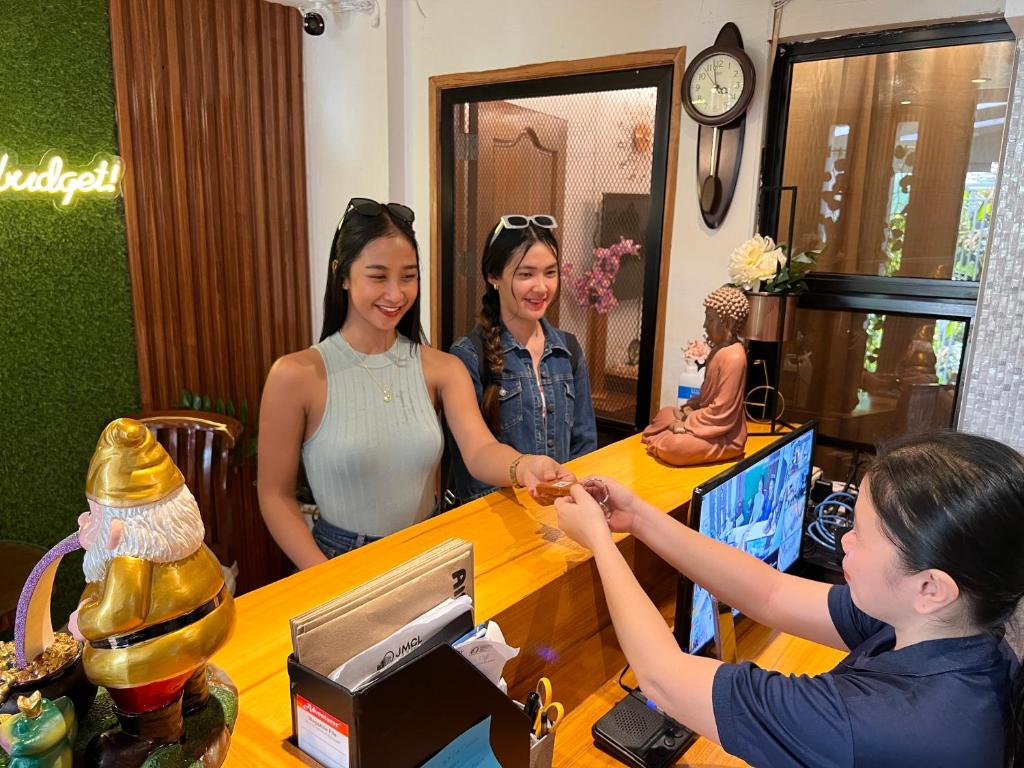 two women standing at a counter in a hair salon at JMCL RESIDENCES in Tacloban