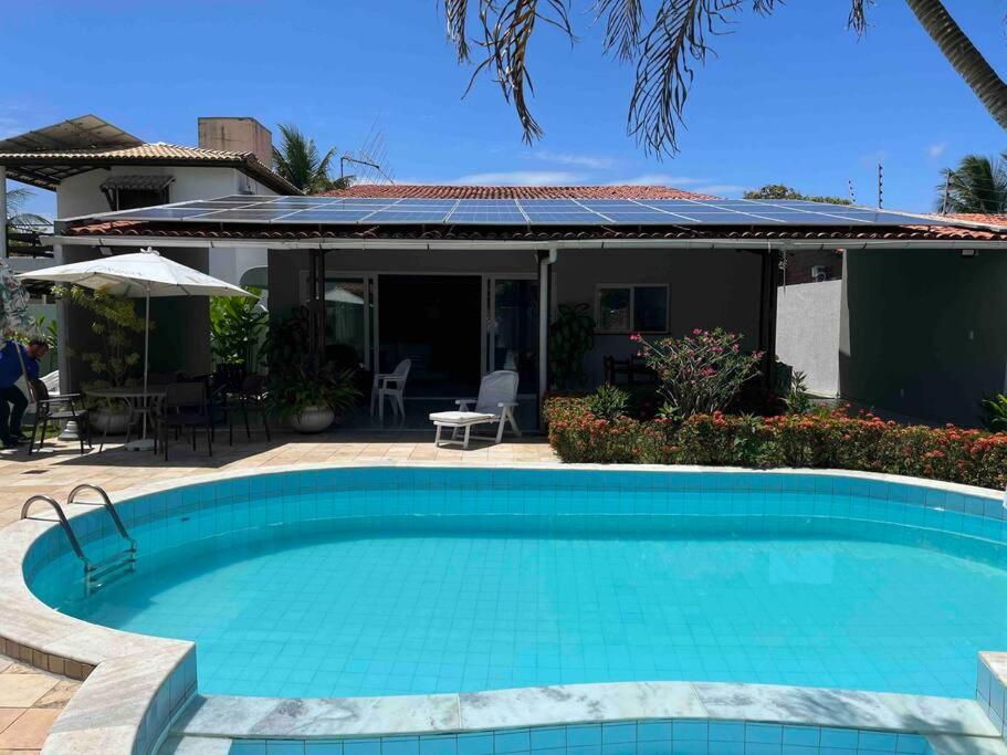een zwembad voor een huis bij Casa di Barra in Barra de São Miguel