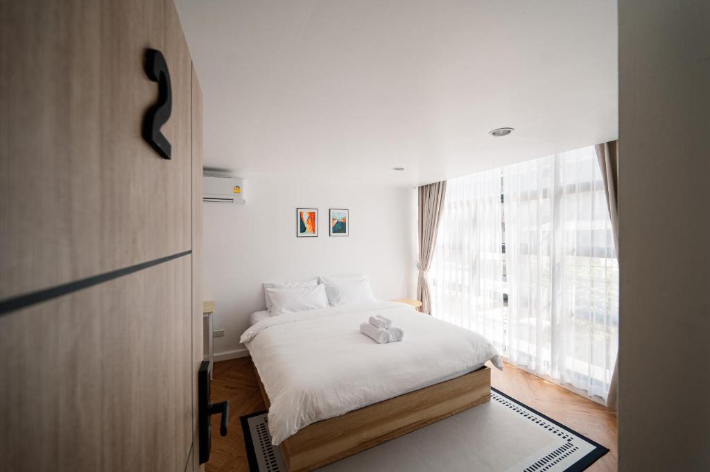 Postel nebo postele na pokoji v ubytování Mitt Haus (Lat Phrao Soi 5)
