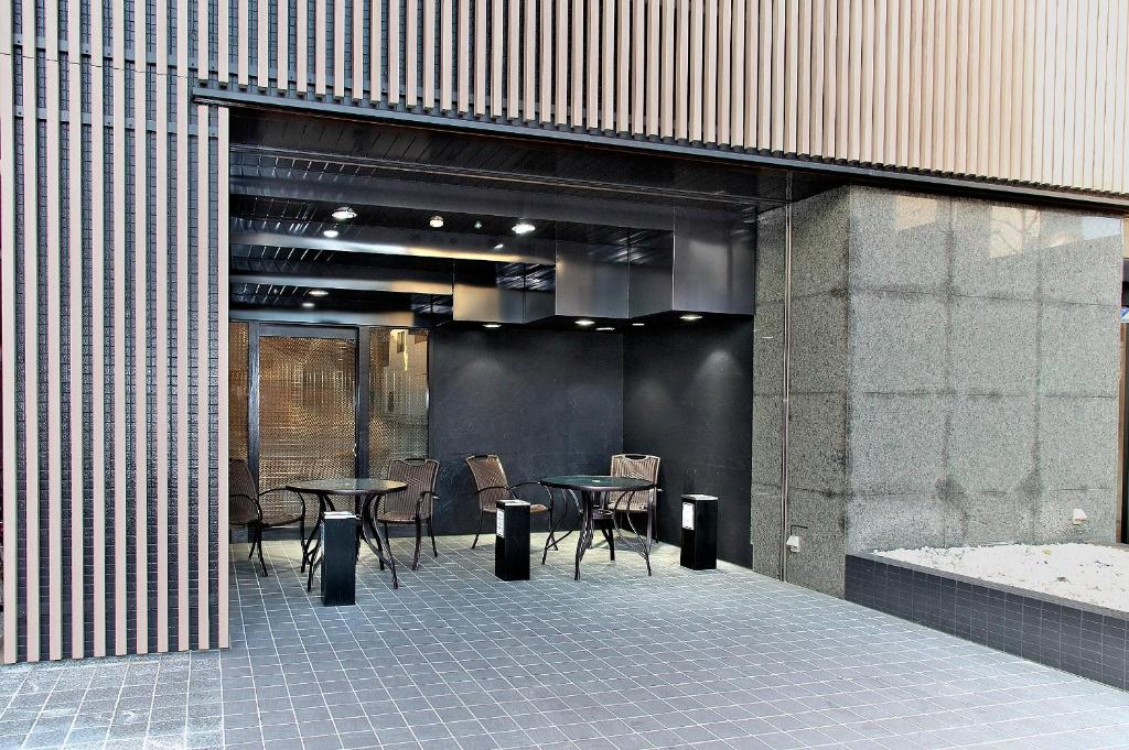 a room with tables and chairs in a building at Hotel Crown Hills Toyohashi in Toyohashi