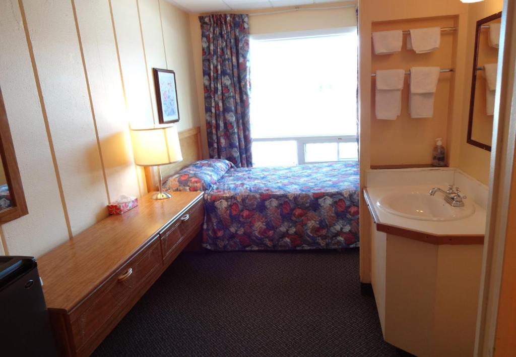 Postel nebo postele na pokoji v ubytování Motel Tremblant