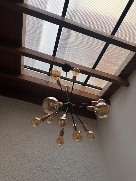 a chandelier hanging from a ceiling in a room at Habitación 209 Luxury Laureles - Estadio in Medellín