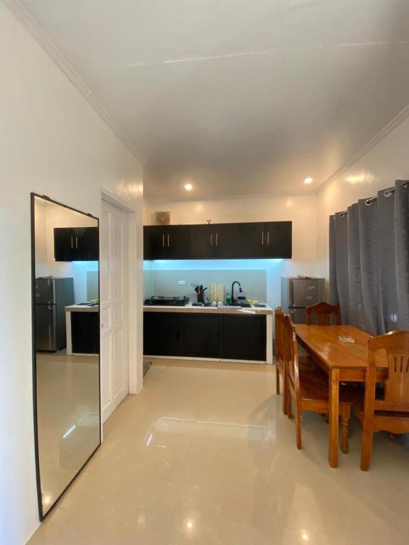 a kitchen and dining room with a table and a dining room at Casa Luna 4 by Angelito's in General Luna