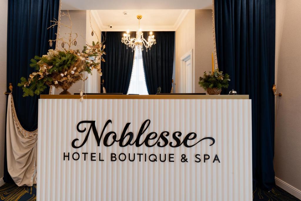 a sign for a hotel boutique and spa at Hotel NOBLESSE Boutique&Spa in Râmnicu Vâlcea