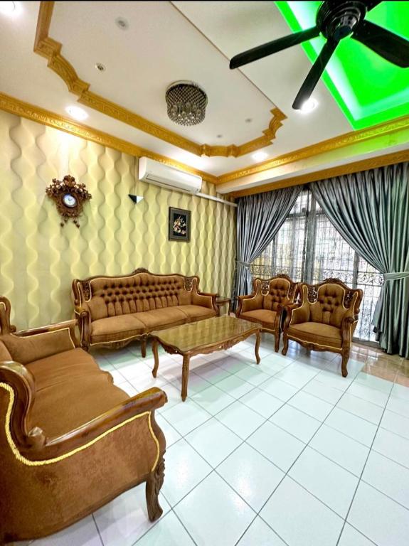 a living room with couches and chairs and a ceiling at Melody D’Rimba Sandakan in Sandakan