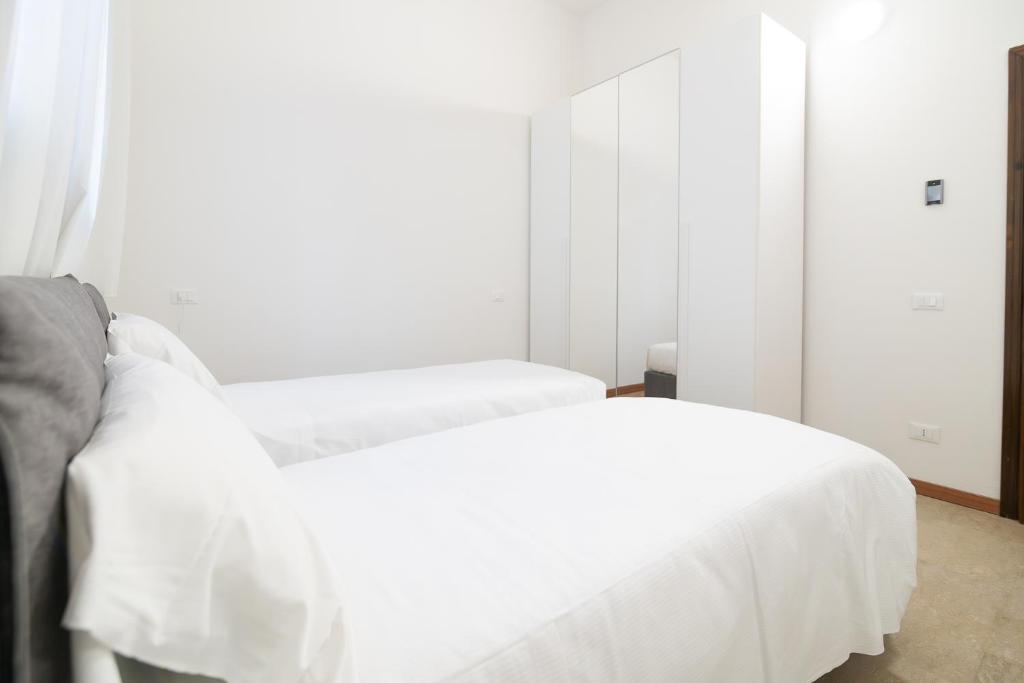 Katil atau katil-katil dalam bilik di Residenza Corso Palladio 159