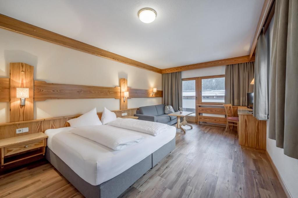 a hotel room with a bed and a television at Tilia living in Ried im Oberinntal