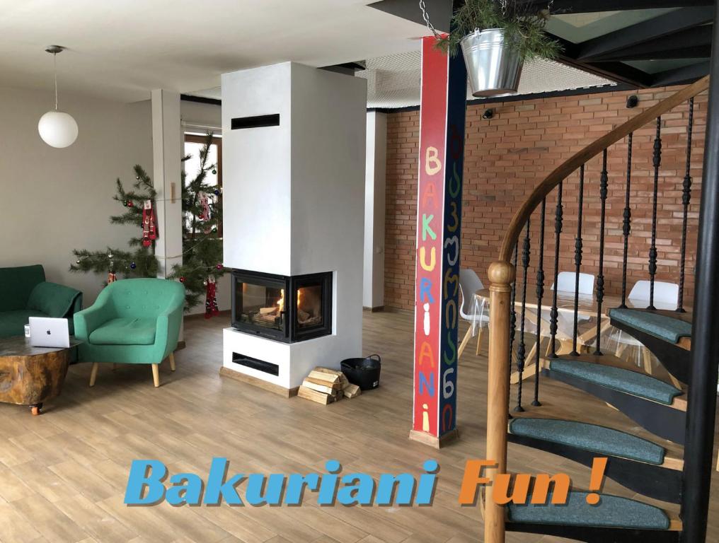 ein Wohnzimmer mit einem Kamin und einer Treppe in der Unterkunft Bakuriani Fun, nice view and design, cosy and spacious in Bakuriani