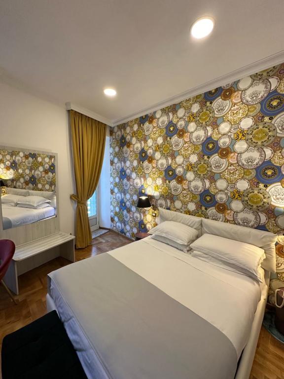 a bedroom with a bed and a wall with plates at Hotel Cinquantatre in Rome