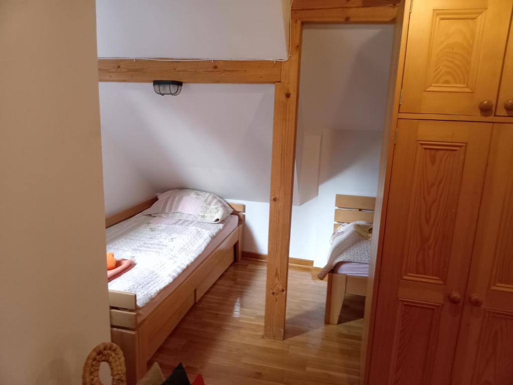 a small bedroom with a bunk bed and a closet at Apartmani - Mesko vajat in Divčibare