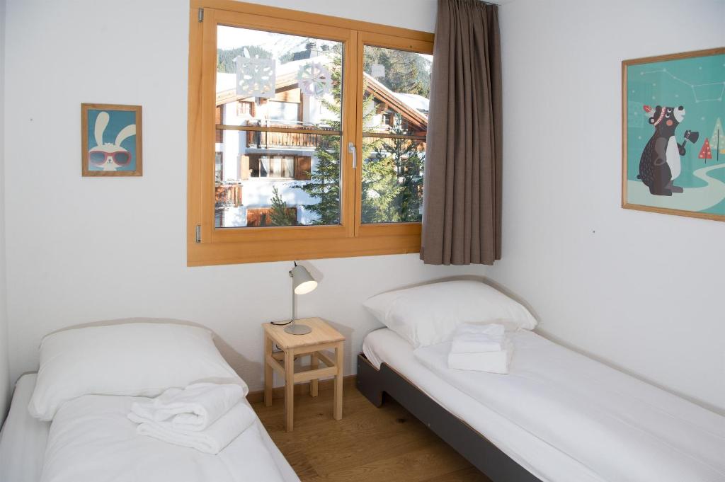 Postel nebo postele na pokoji v ubytování Holiday flat for 6 people Sot Valos Lenzerheide centre