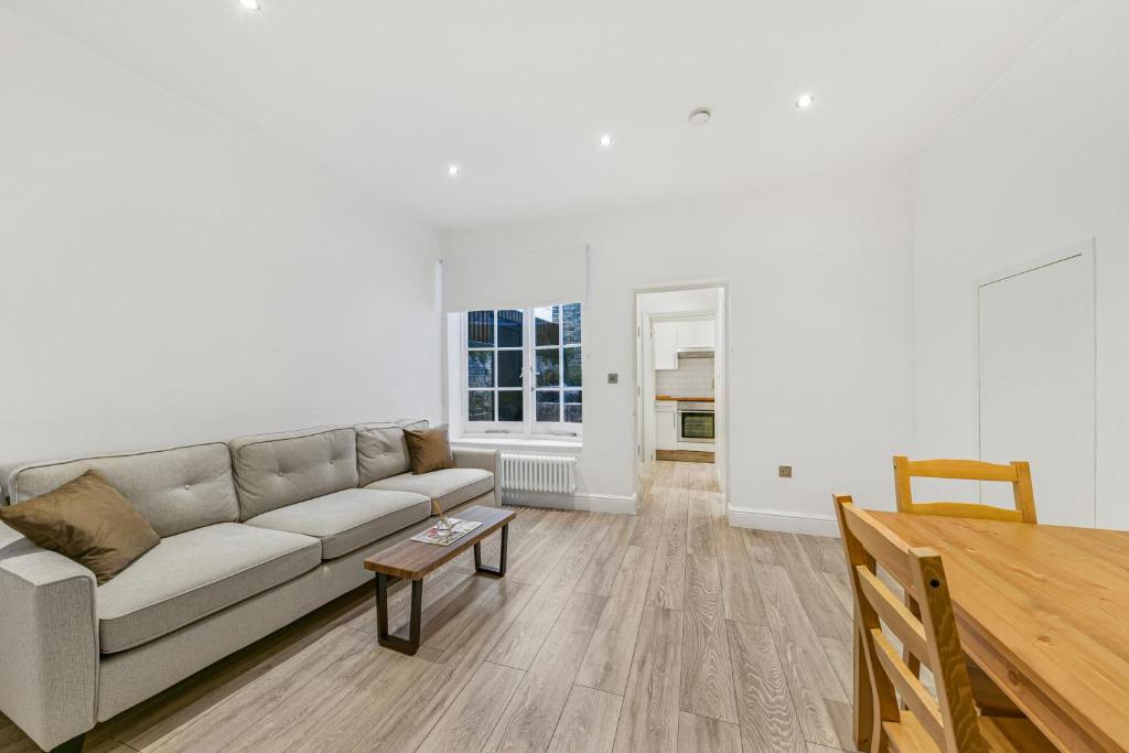 a living room with a couch and a table at The Knightsbridge Deluxe Apart in London