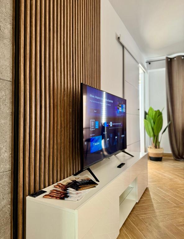 a living room with a flat screen tv on a white cabinet at Apartament Ula in Nysa