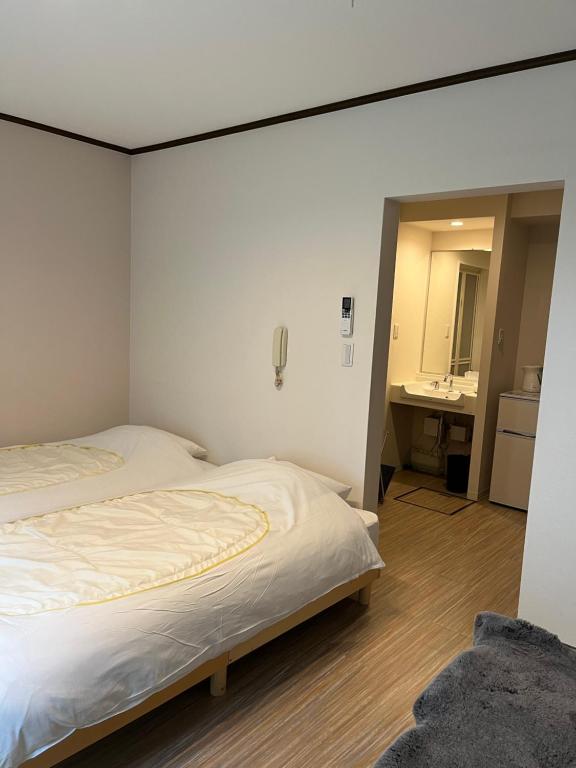 Postel nebo postele na pokoji v ubytování Koyasan Guest House Tommy