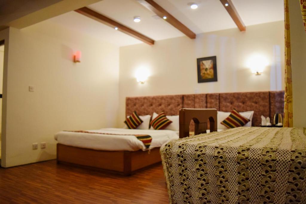 Postel nebo postele na pokoji v ubytování Kathmandu Prince Hotel