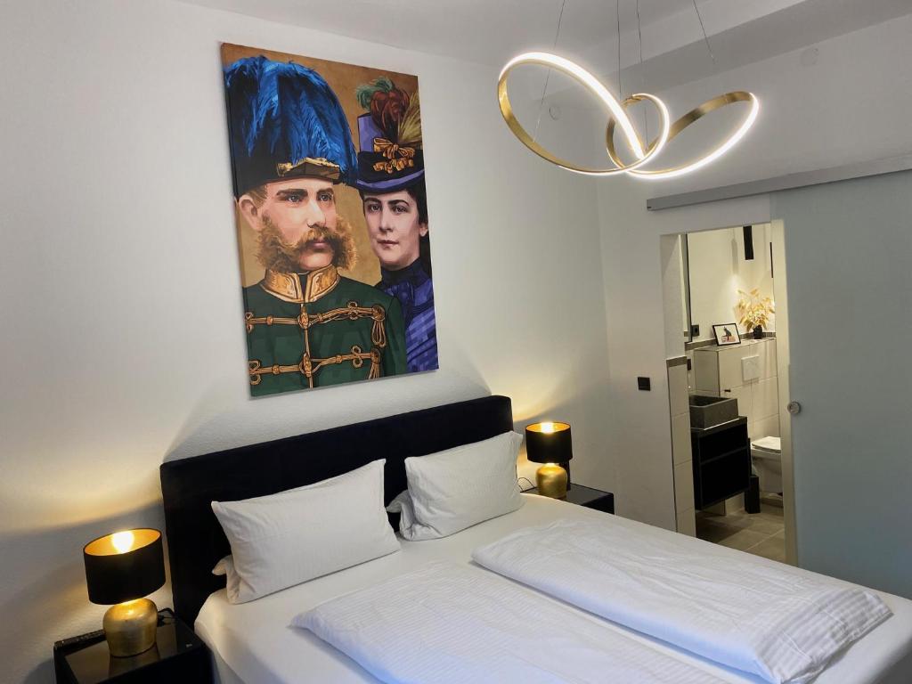a bedroom with a large painting above a bed at Pension und Ferienwohnung Frech in Marktschellenberg