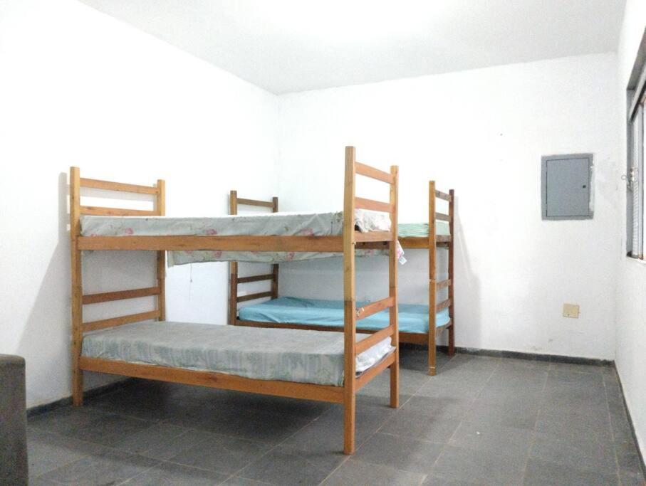 a room with three bunk beds in a room at Casa mobiliada individual in Campinas