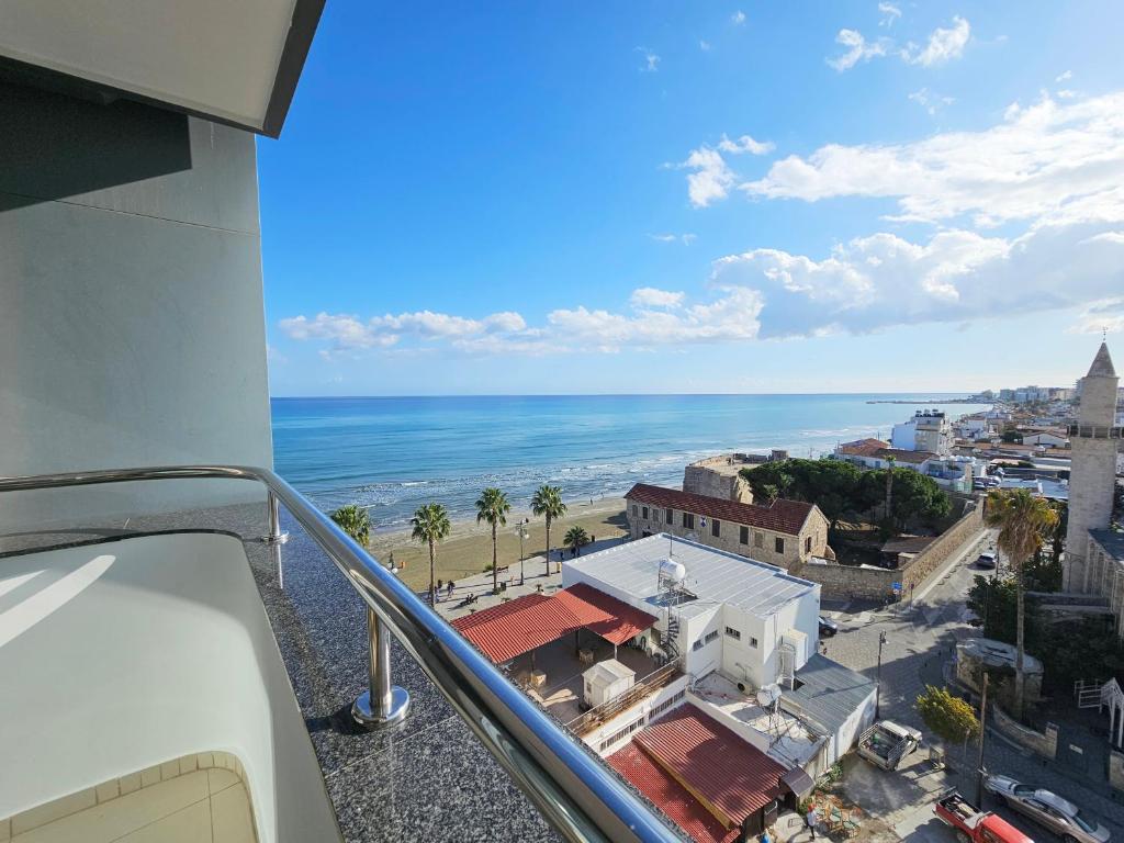 a view of the ocean from a balcony of a building at Dios Ponte Finikoudes Beachfront Duplex Penthouse in Larnaka
