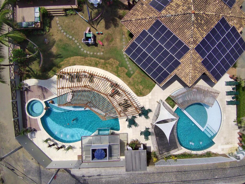 an overhead view of a swimming pool with solar panels at Pousada Praia Bela in Ilhéus