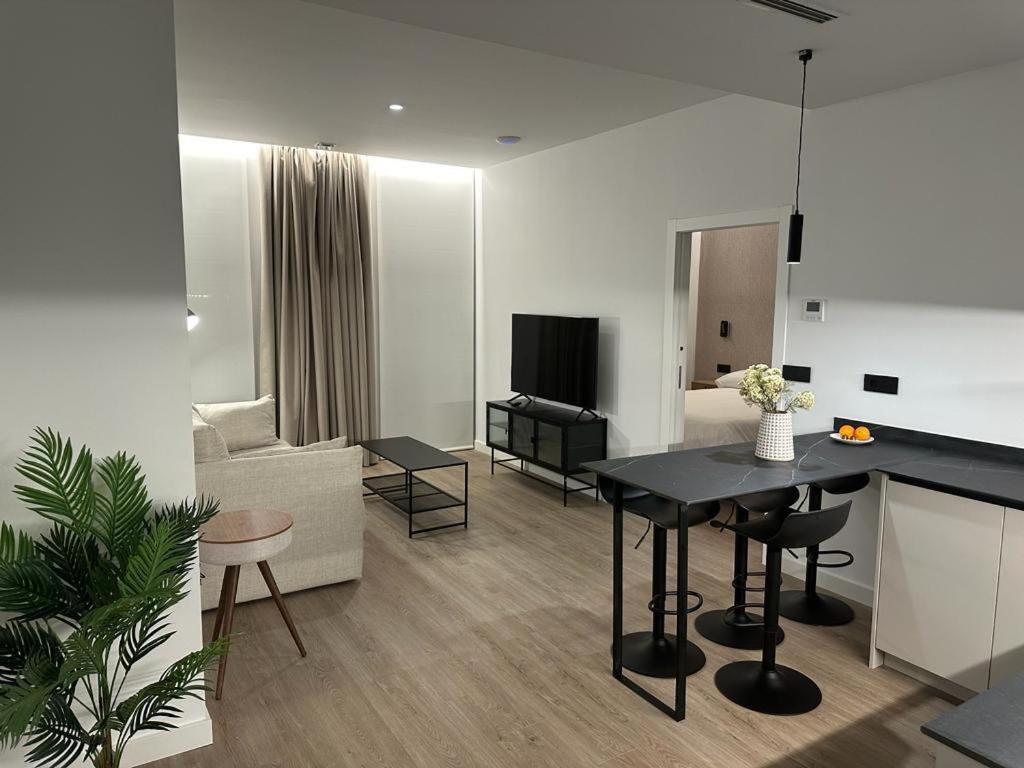 a living room with a black table and a living room at Demetrio By Alma Suites in Valencia