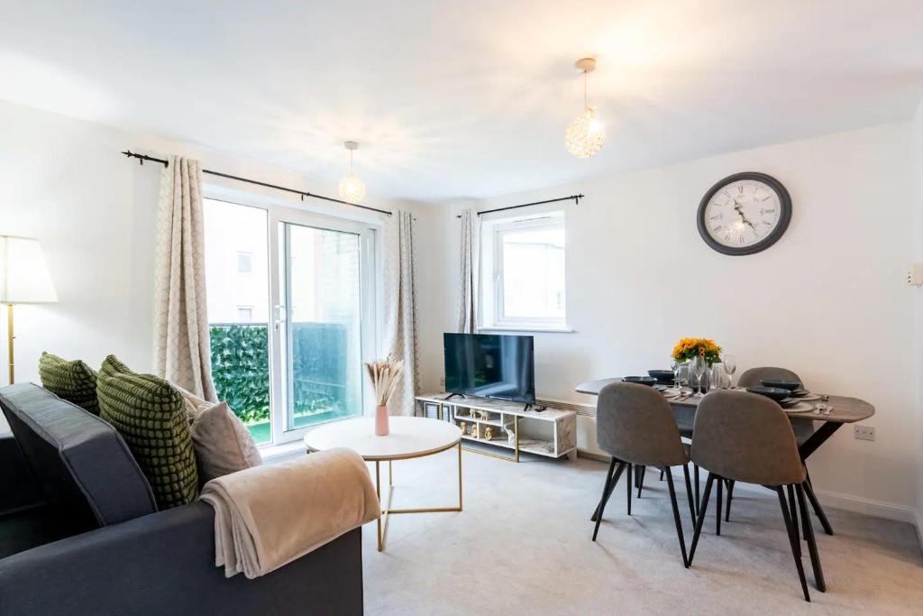 a living room with a couch and a table at Live the Wembley Buzz! Stylish Flat near Station & Amenities in London