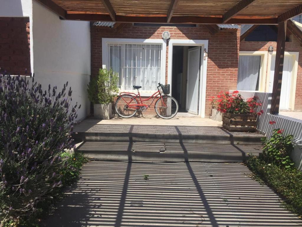 a red bike parked on the front porch of a house at Duplex Marea Baja in Playa Unión