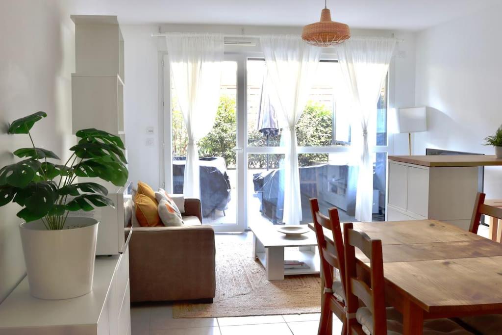 a living room with a table and a couch at Apartment in Ferney close to Geneva United Nations in Ferney-Voltaire