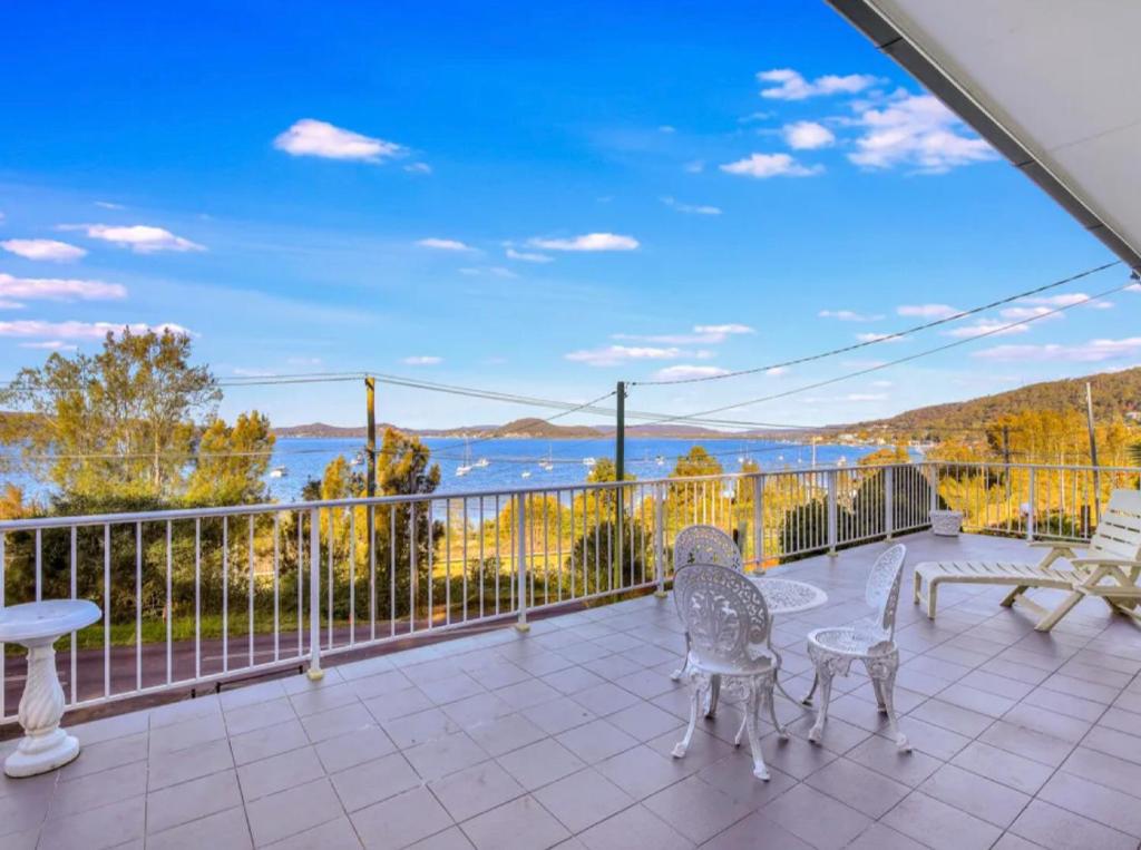 a balcony with chairs and a view of the water at Water view retreat sanctuary in Koolewong